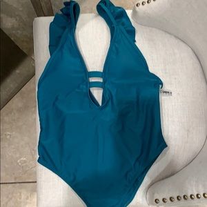 One piece teal plunging neckline suit